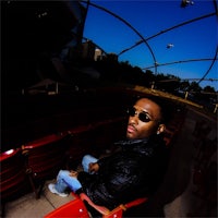 a man in sunglasses sitting in an auditorium